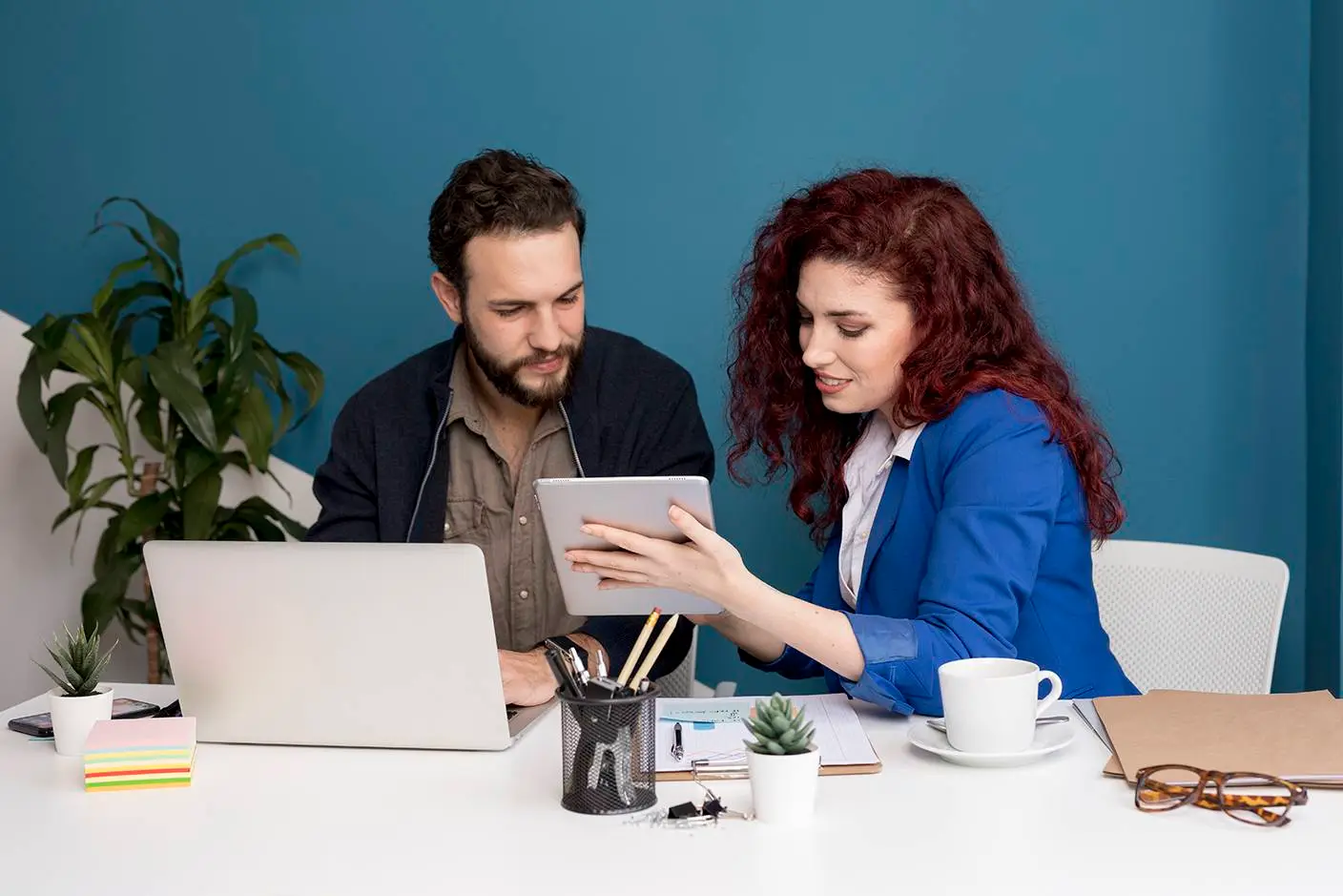 Colleagues reviewing tablet together |Titanium Dash